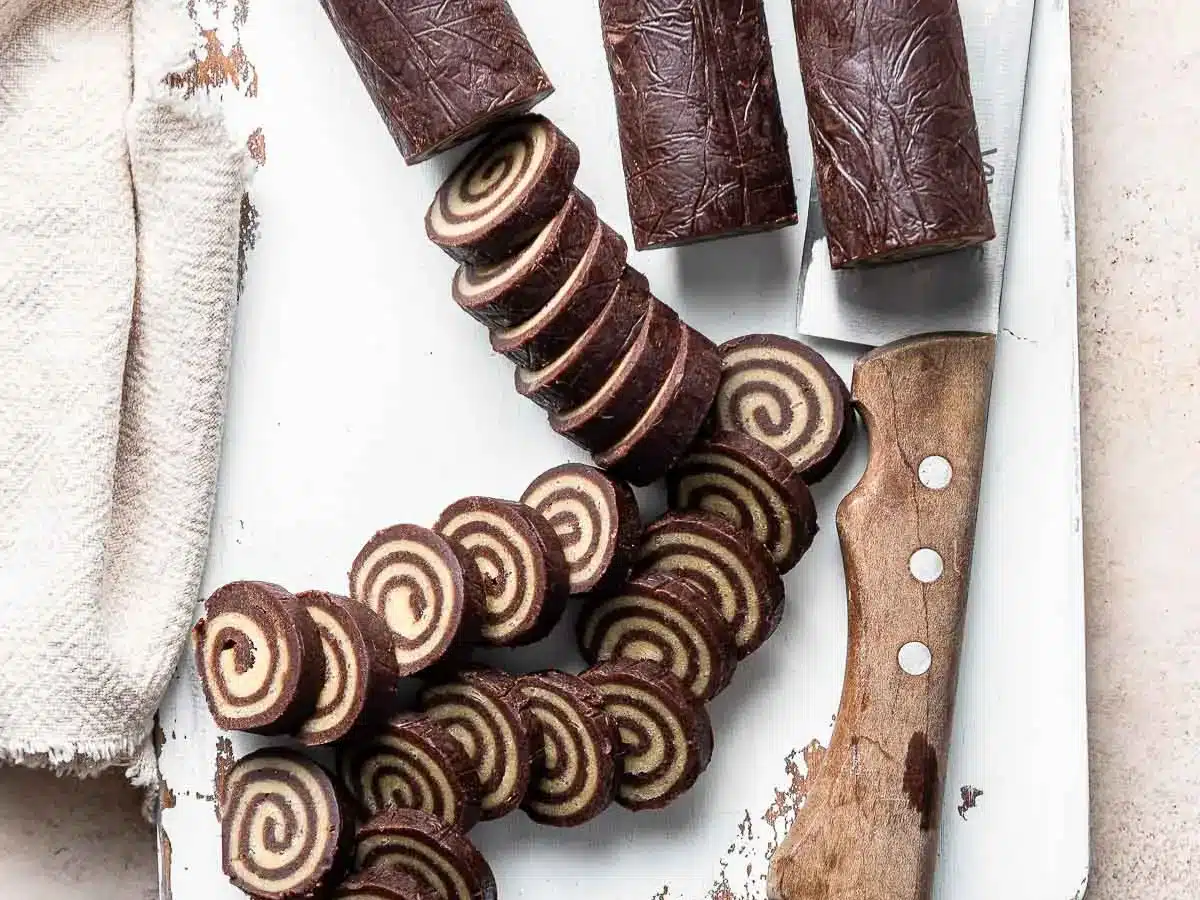 Cookie dough rolled into swirls and cut into slices on a cutting board