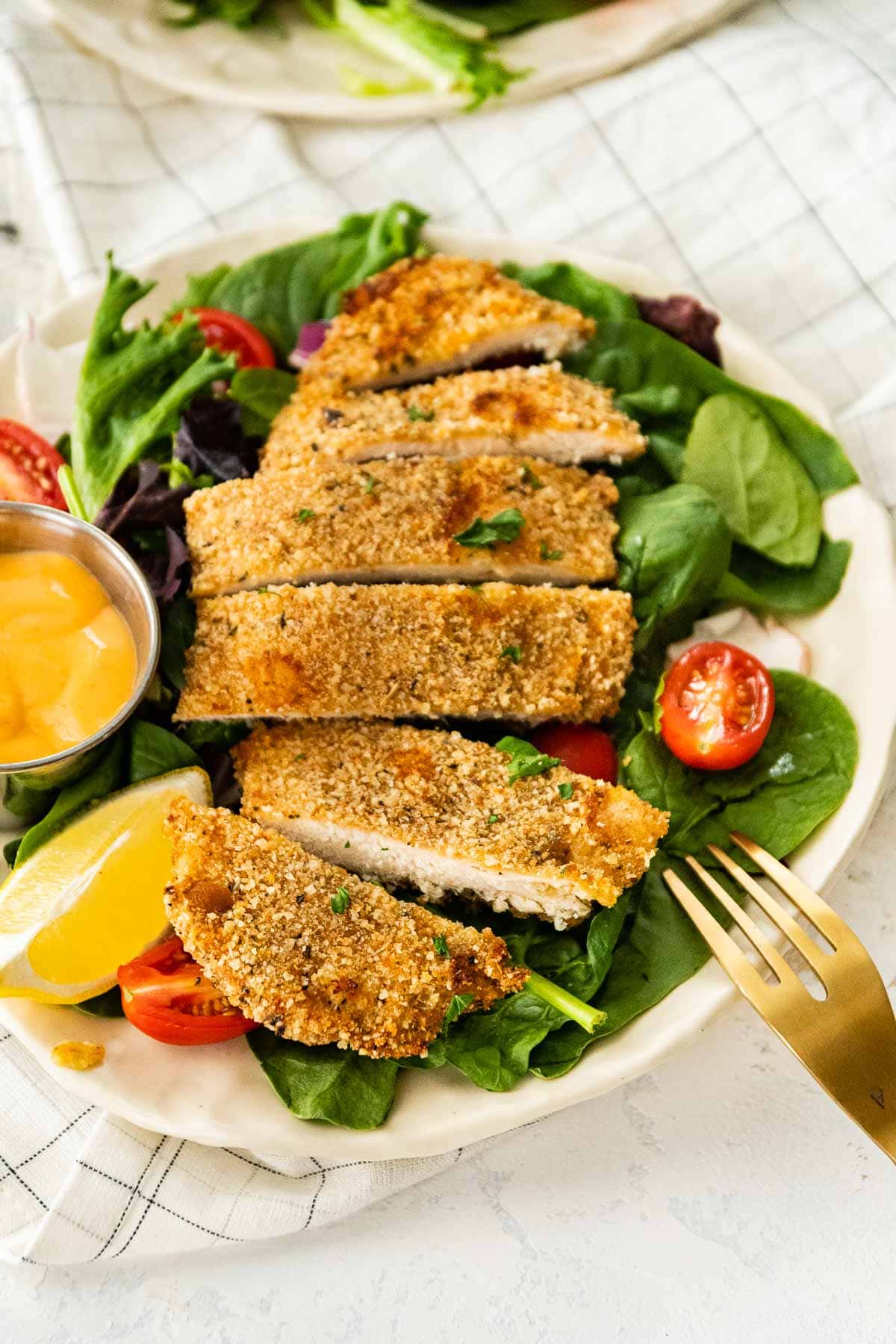 Baked Breaded Chicken sliced on serving plate