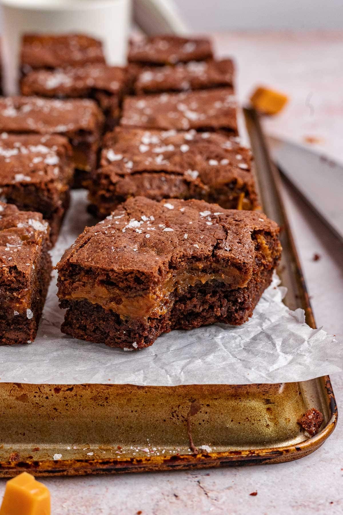 Caramel Stuffed Brownies sliced on cutting board with a bite missing