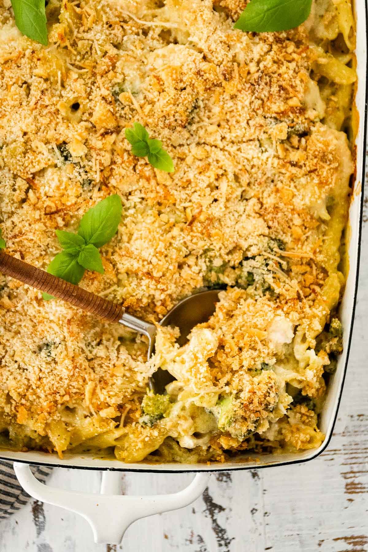 Chicken Broccoli Pasta Bake scooping from baking dish