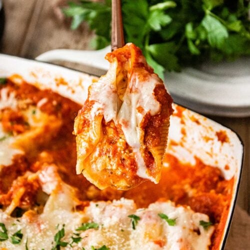 Chicken Parmesan Stuffed Shells in baking pan with closeup of spoonful 1x1