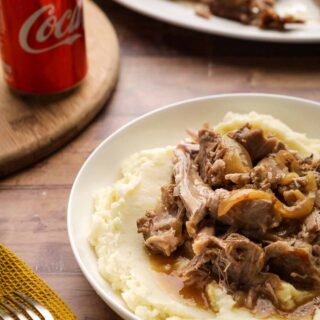 Coca-Cola Pork Roast on serving plate over mashed potatoes 1x1