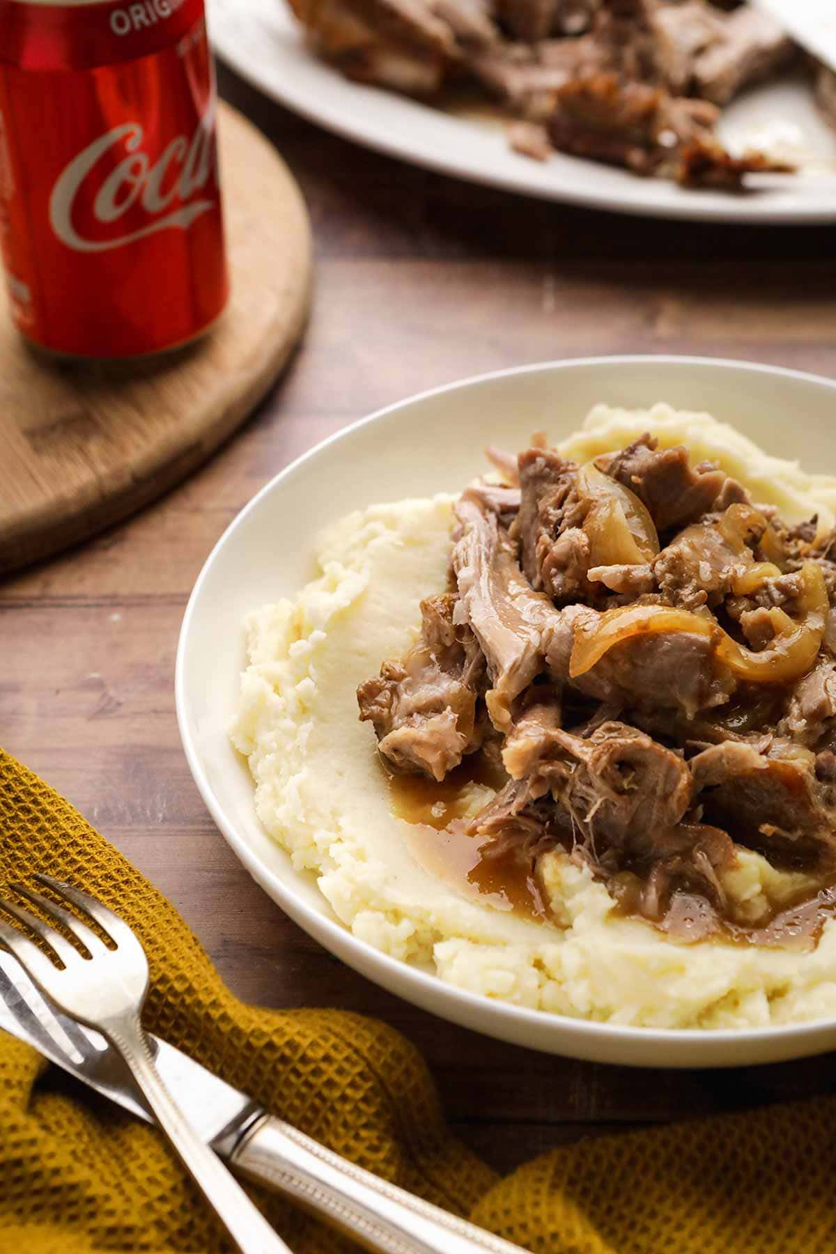 Coca-Cola Pork Roast on serving plate over mashed potatoes