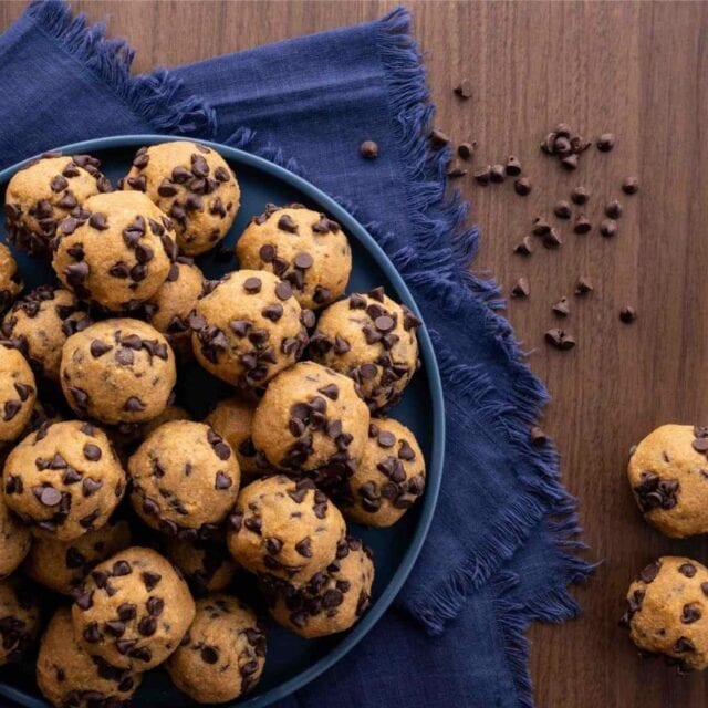 bowl of cookie dough bites on blue napkin