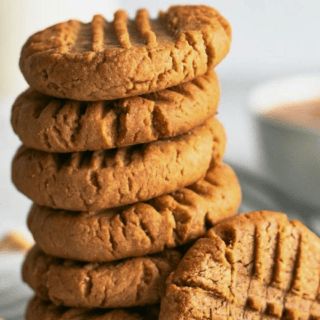 nutty cookies stacked on one another with one leaning on the side