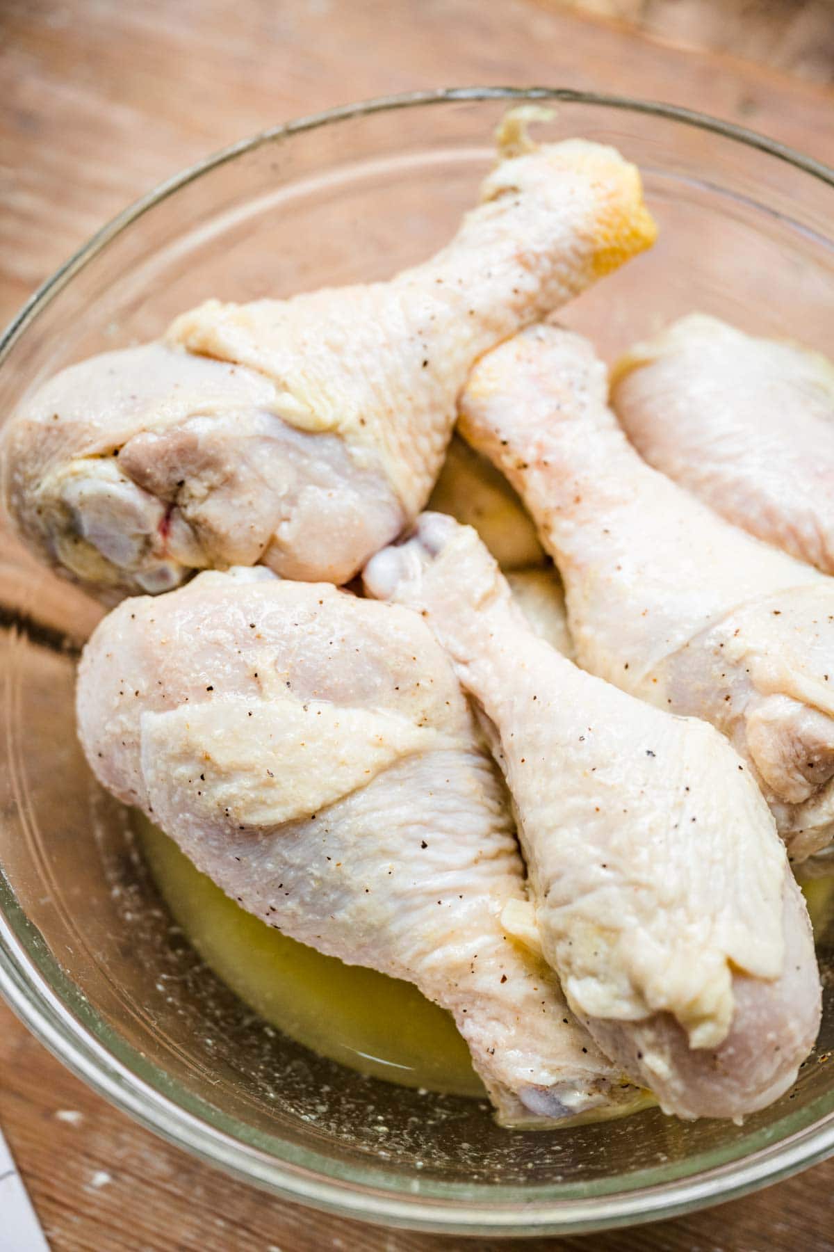 Grilled Drumsticks chicken in marinade in bowl