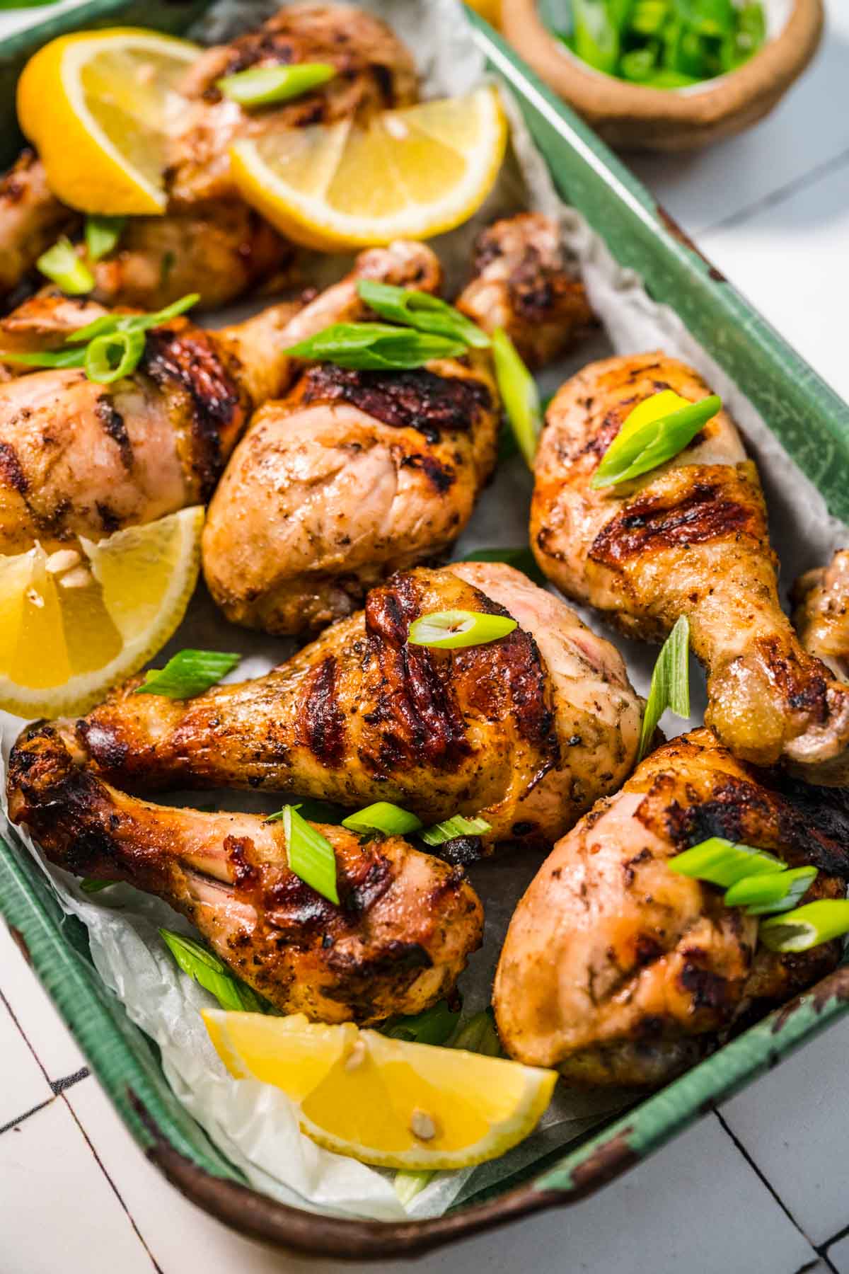 Grilled Drumsticks with garnish in serving dish