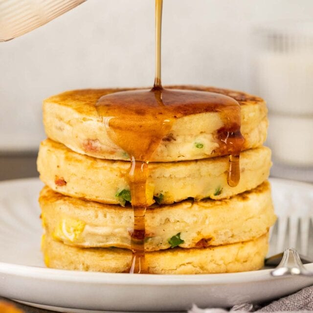 Loaded Breakfast Pancakes stack on serving plate with syrup 1x1