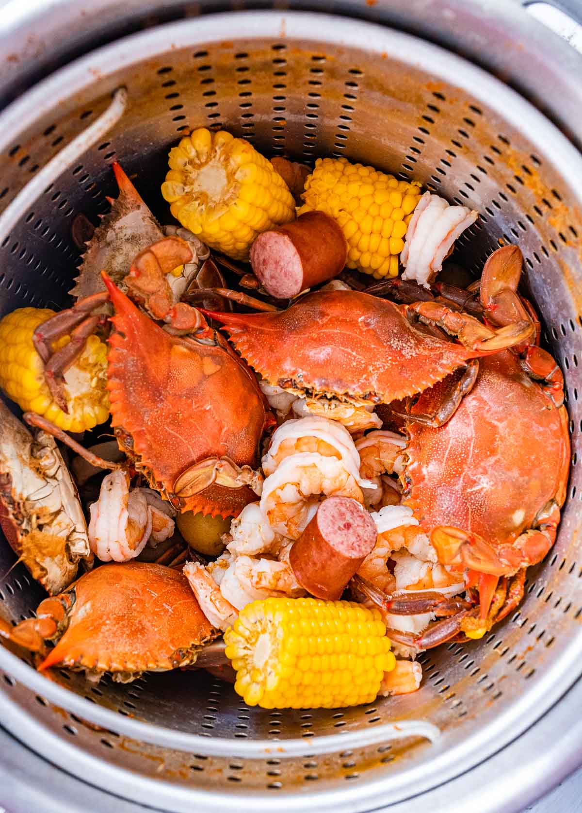 Low Country Boil cooked crab, corn, sausage, and potatoes in pot