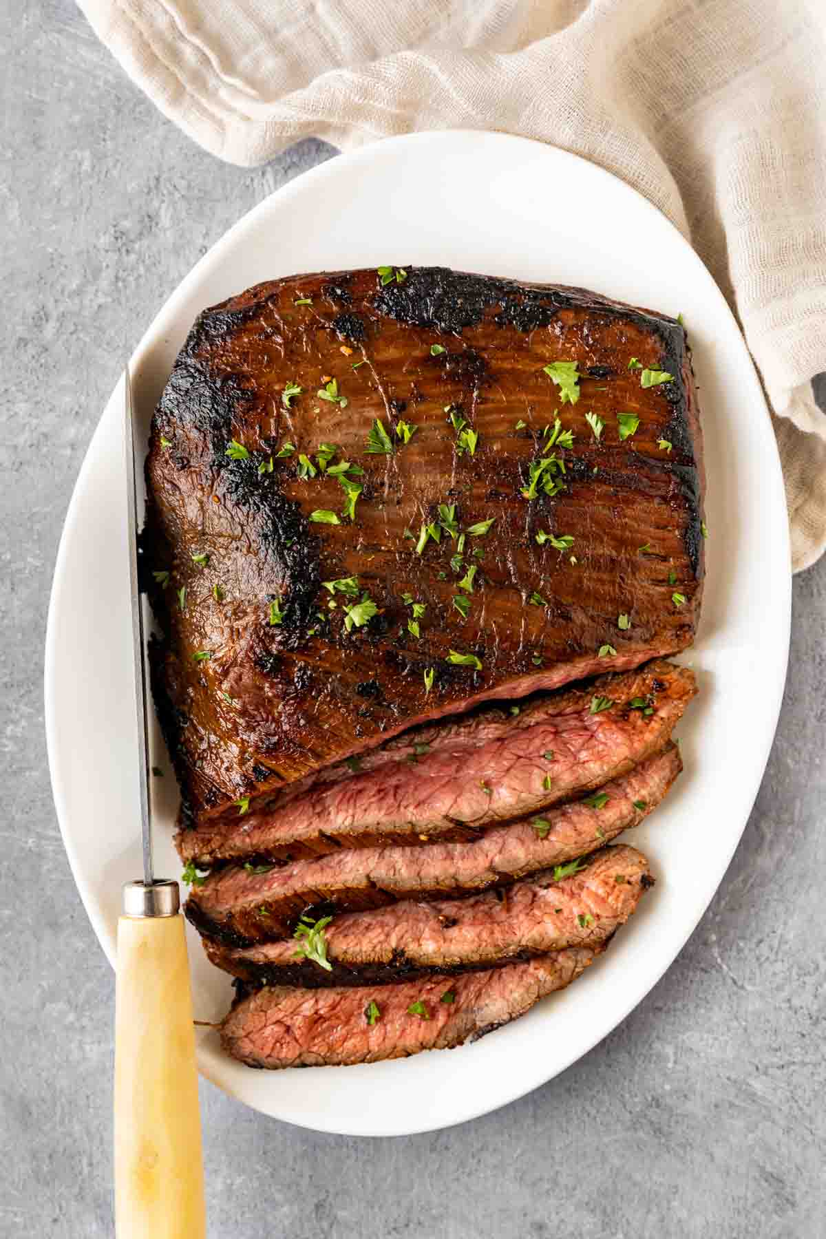 Marinated Flank Steak sliced on serving platter