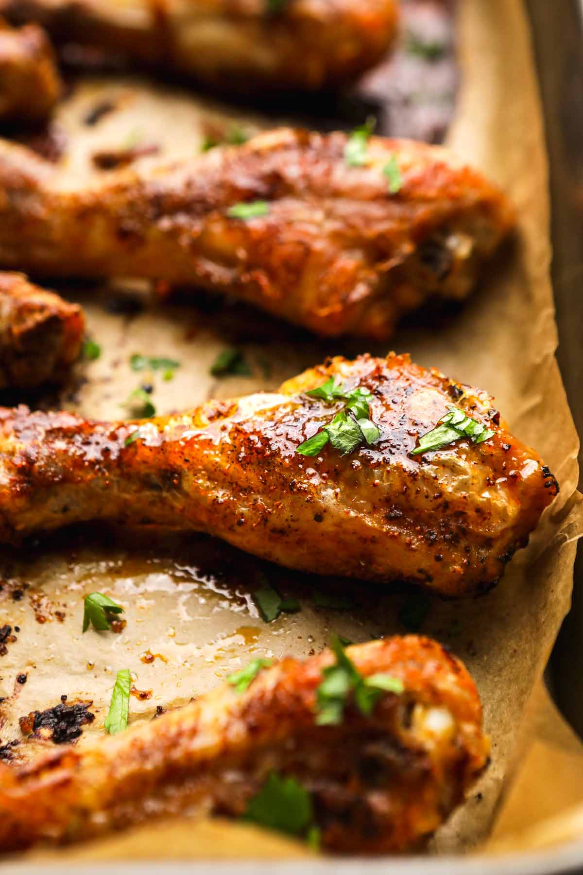 Oven Baked Chicken Drumsticks on baking pan closeup