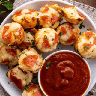 top down view of plate of bites being served with small bowl of marinara sauce