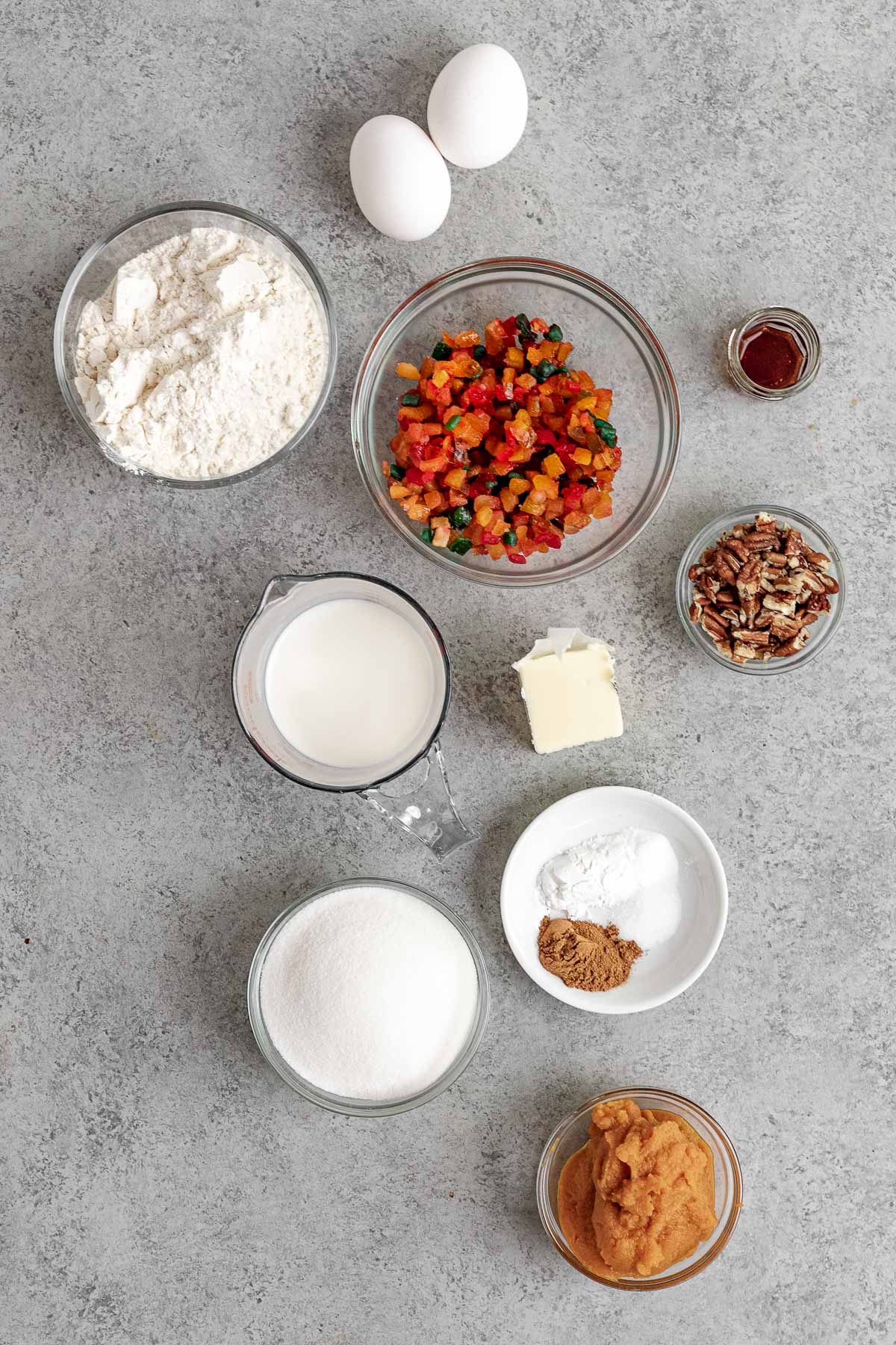 Pumpkin Fruitcake ingredients spread out on counter in separate bowls