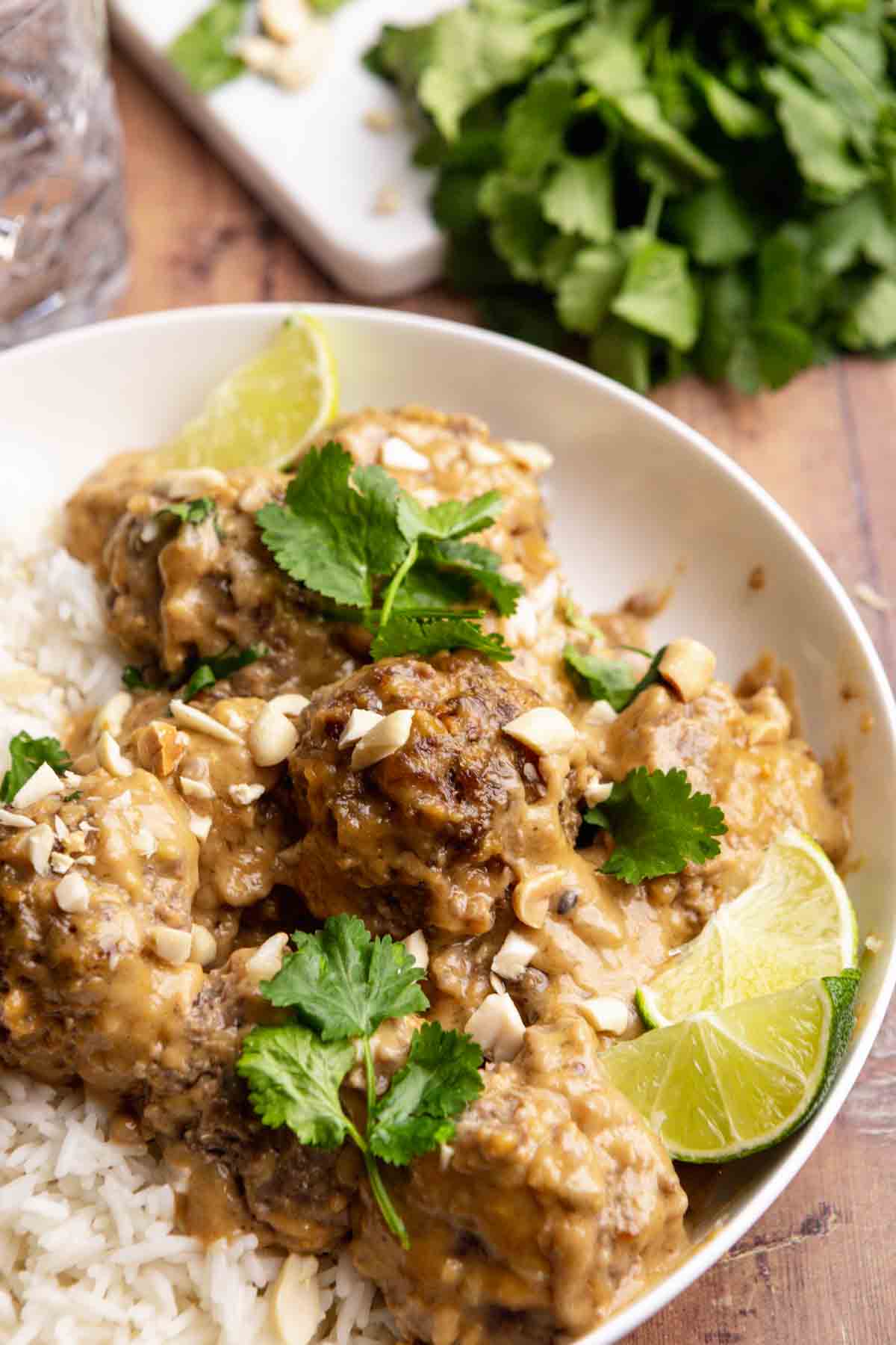 Thai Peanut Satay Meatballs over rice on serving plate