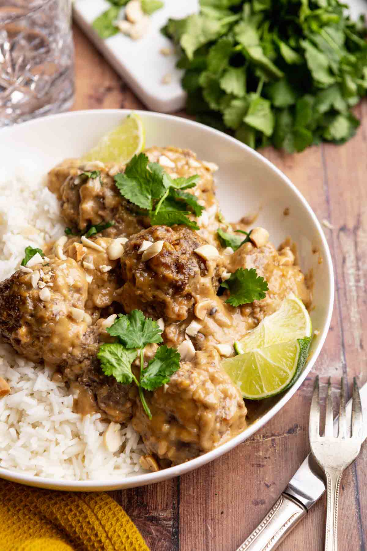 Thai Peanut Satay Meatballs over rice on serving plate