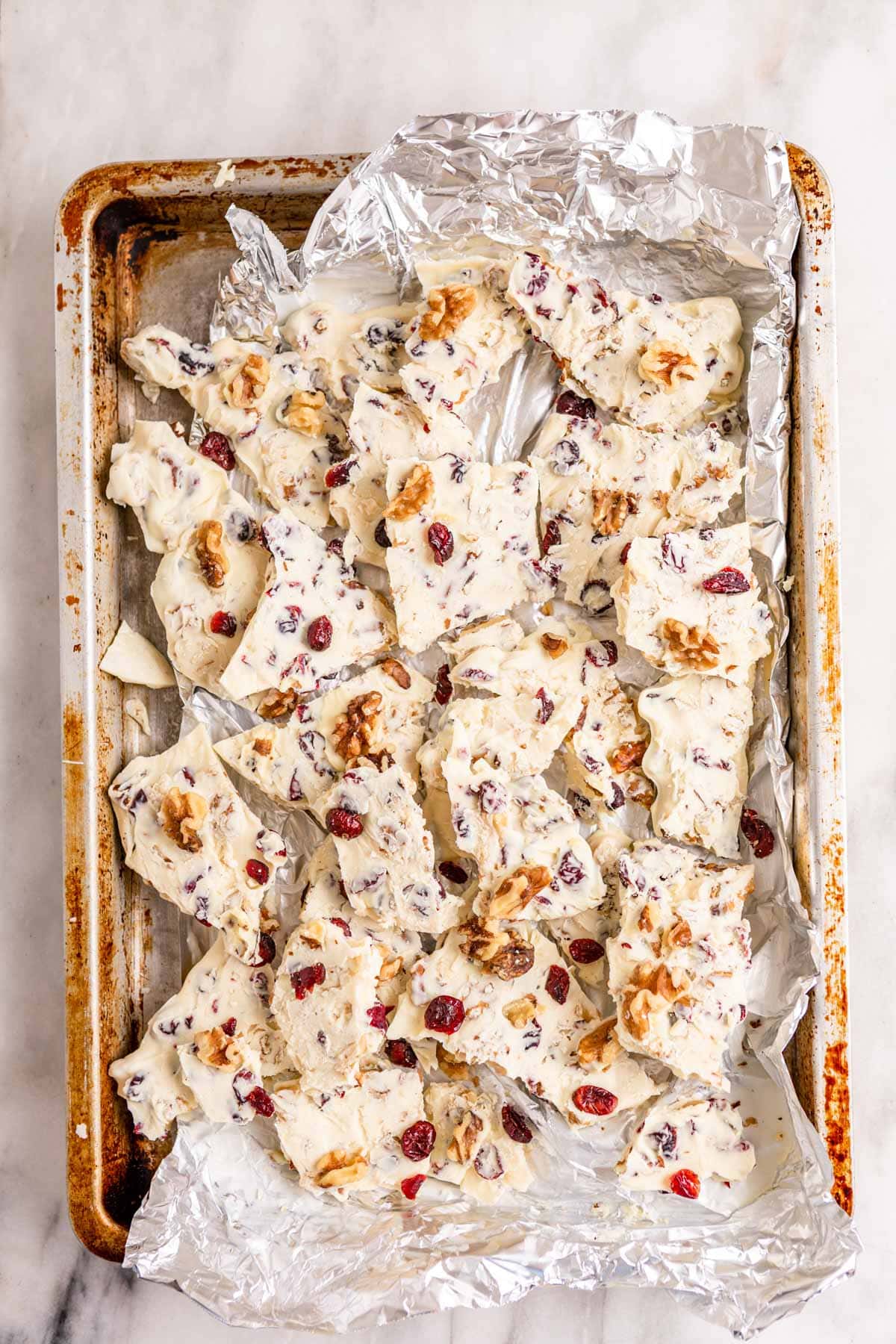 White Chocolate Cranberry Bark in pan broken into shards