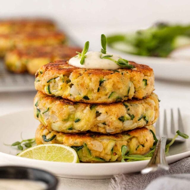 Zucchini Patties stacked on serving plate 1x1