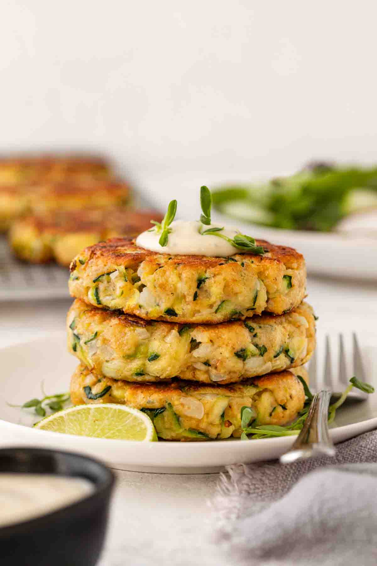 Zucchini Patties stacked on serving plate