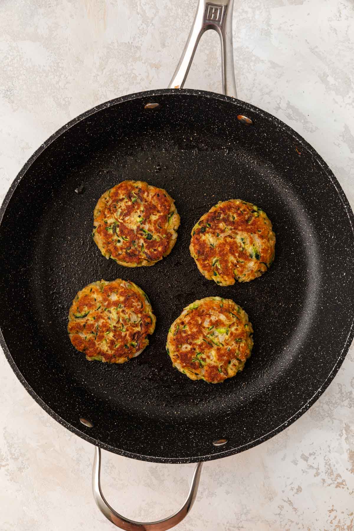 Zucchini Patties in cooking pan