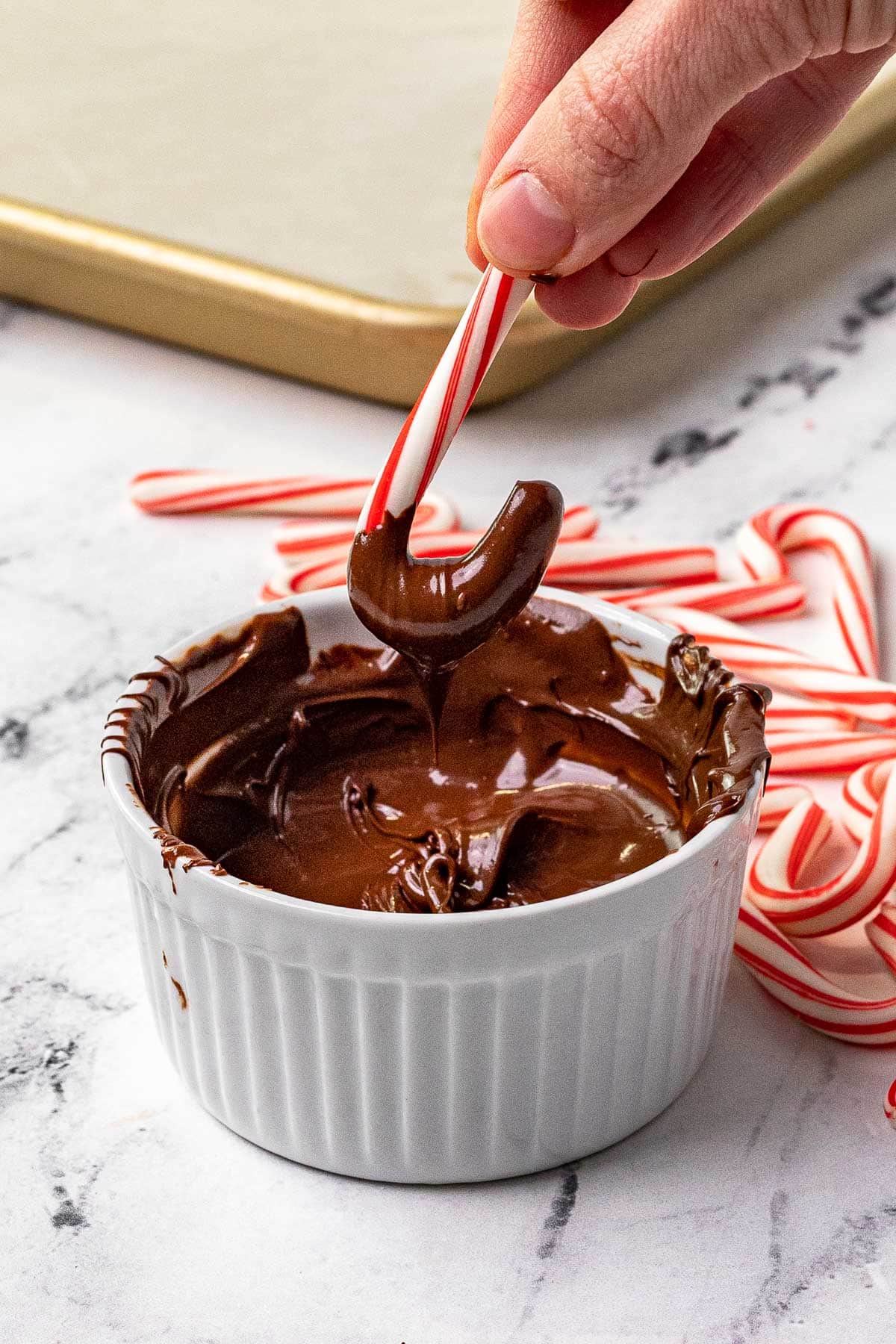 Chocolate Dipped Candy Canes dipping into chocolate