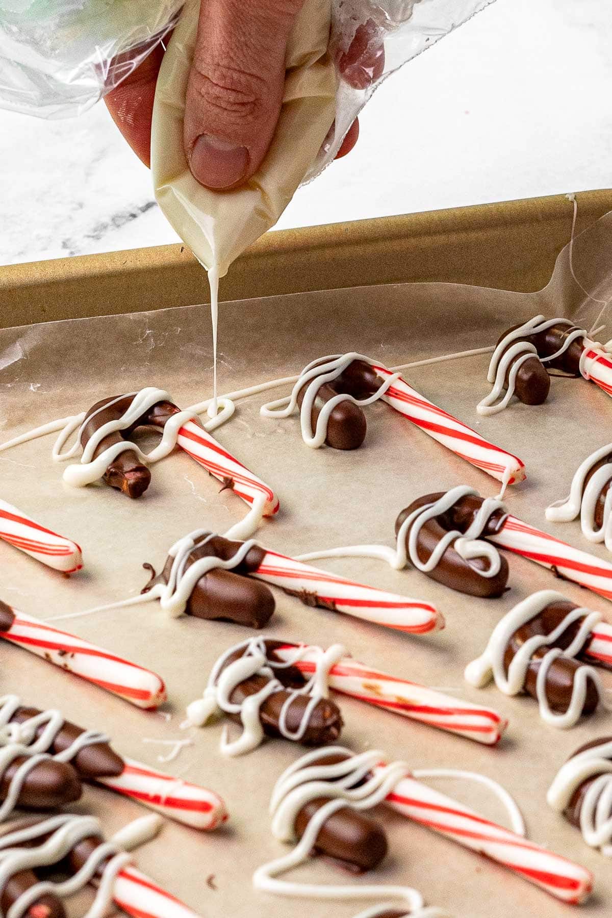 Chocolate Dipped Candy Canes drizzling with white chocolate