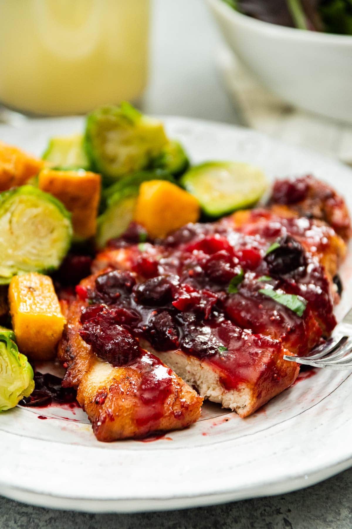Cranberry Chicken sliced on serving plate