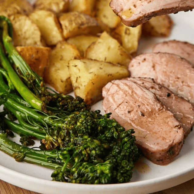sliced on plate with potatoes and broccoli
