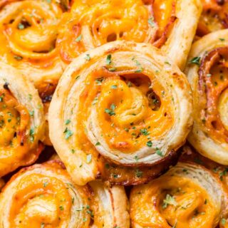 Ham and cheese pinwheels piled on a serving plate