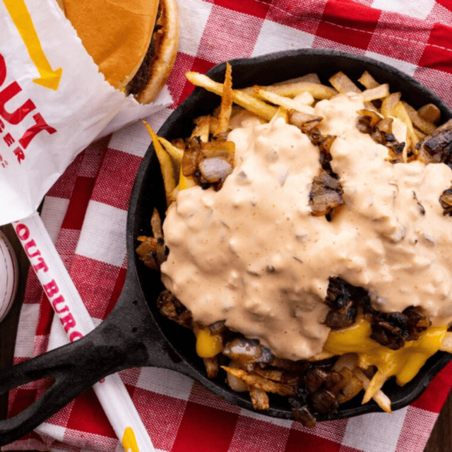 finished fries in a cast iron with toppings