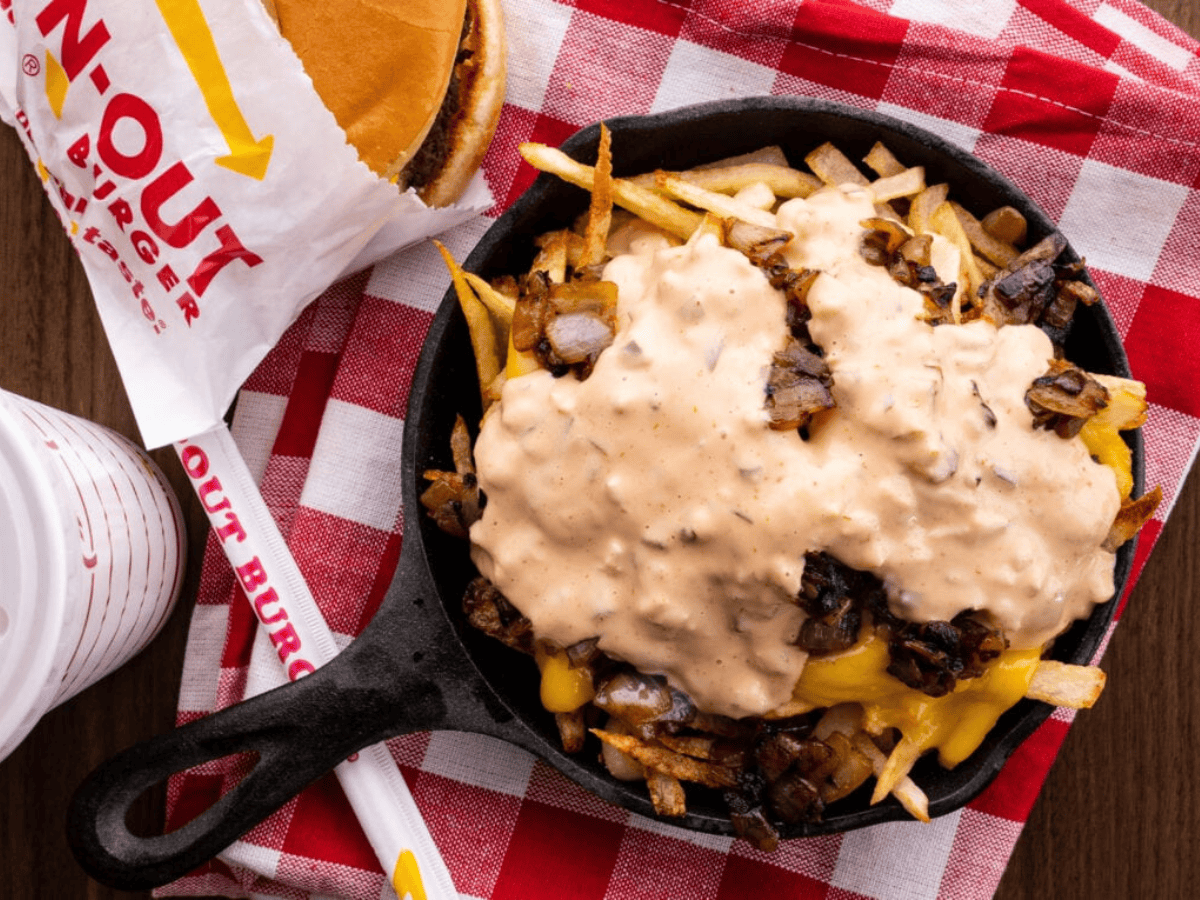 finished fries in a cast iron with toppings 