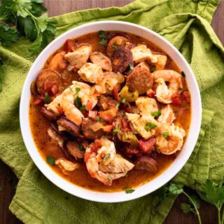 White bowl with prepared shrimp, chicken, and sausage 4x3