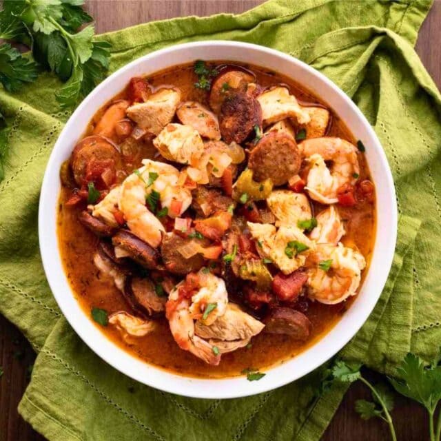 White bowl with prepared shrimp, chicken, and sausage 4x3