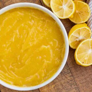 Bowl of finished curd with halved lemons on side