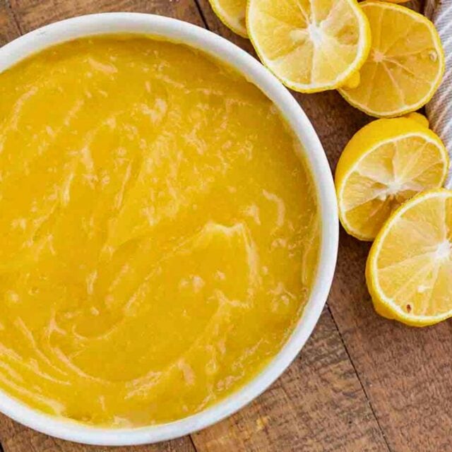Bowl of finished curd with halved lemons on side