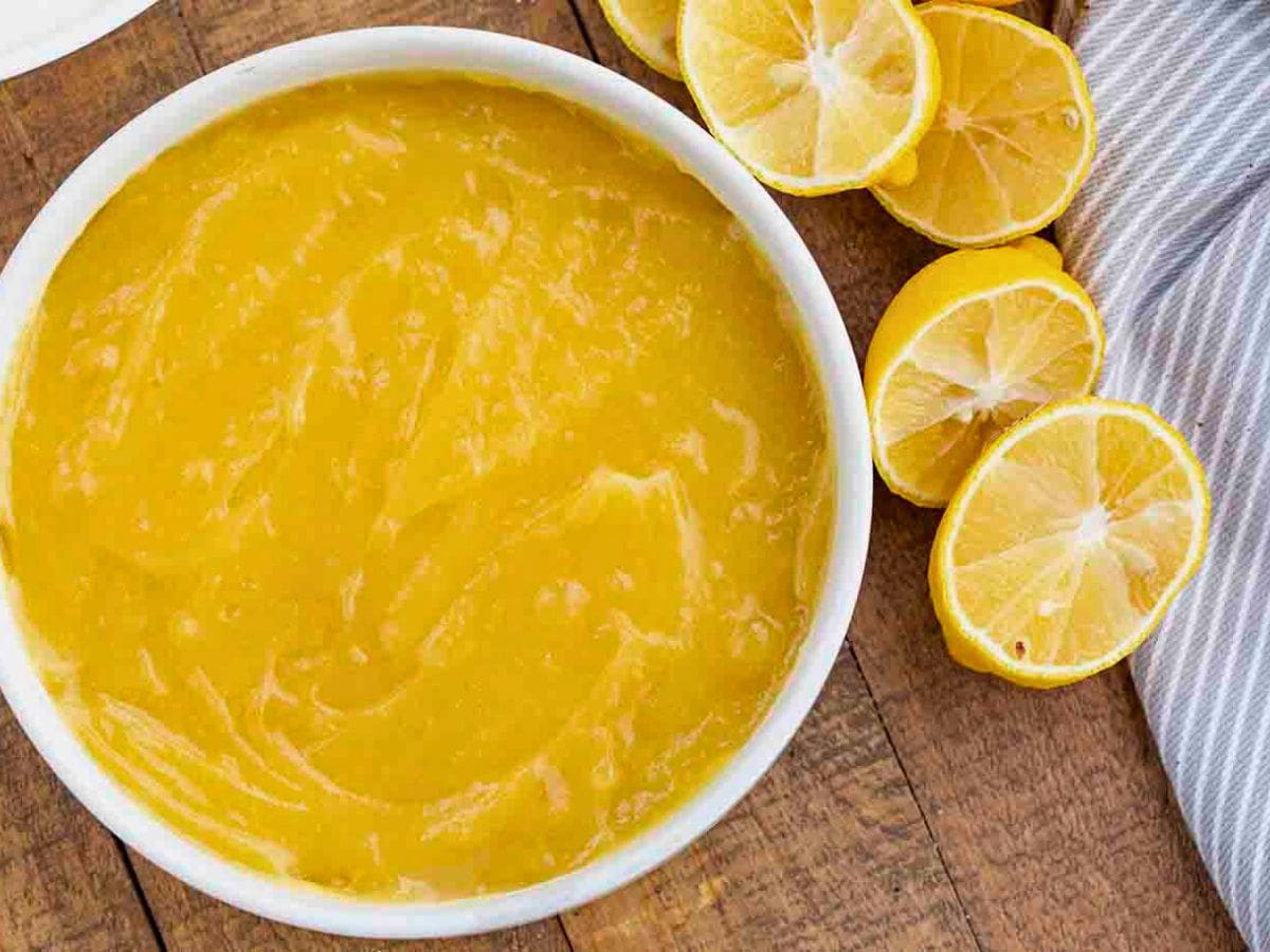 Bowl of finished curd with halved lemons on side