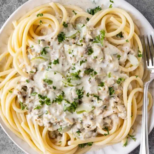 Old Spaghetti Factory White Clam Sauce over pasta on serving dish 4x3