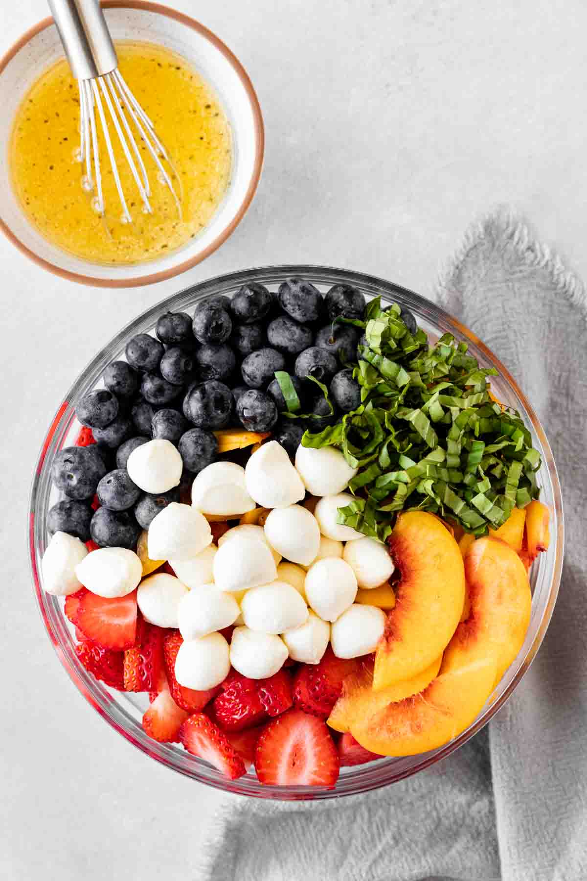 Peach Berry Caprese Salad ingredients in mixing bowl