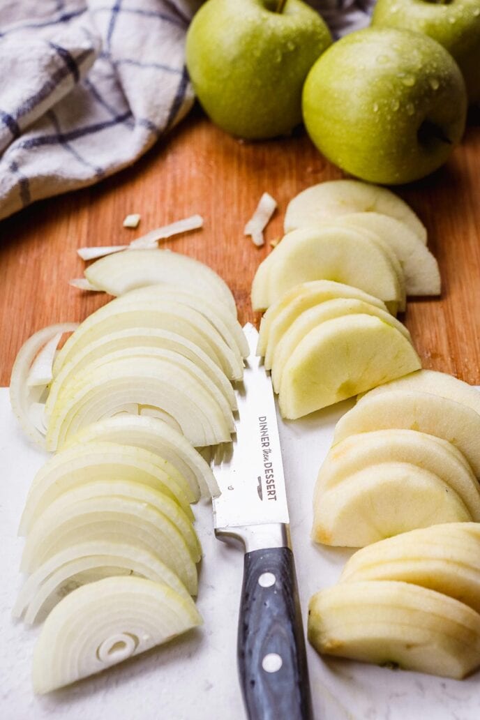 Pork Chops with Apples and Onions peeled apple slices on cutting board with knife