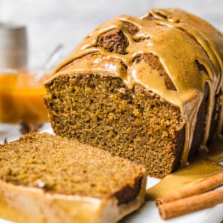 Iced sweet and spiced bread sliced on serving plate.