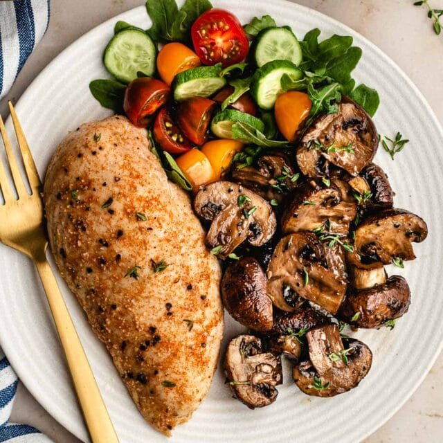 Dinner plate with mushrooms, and chicken breast.