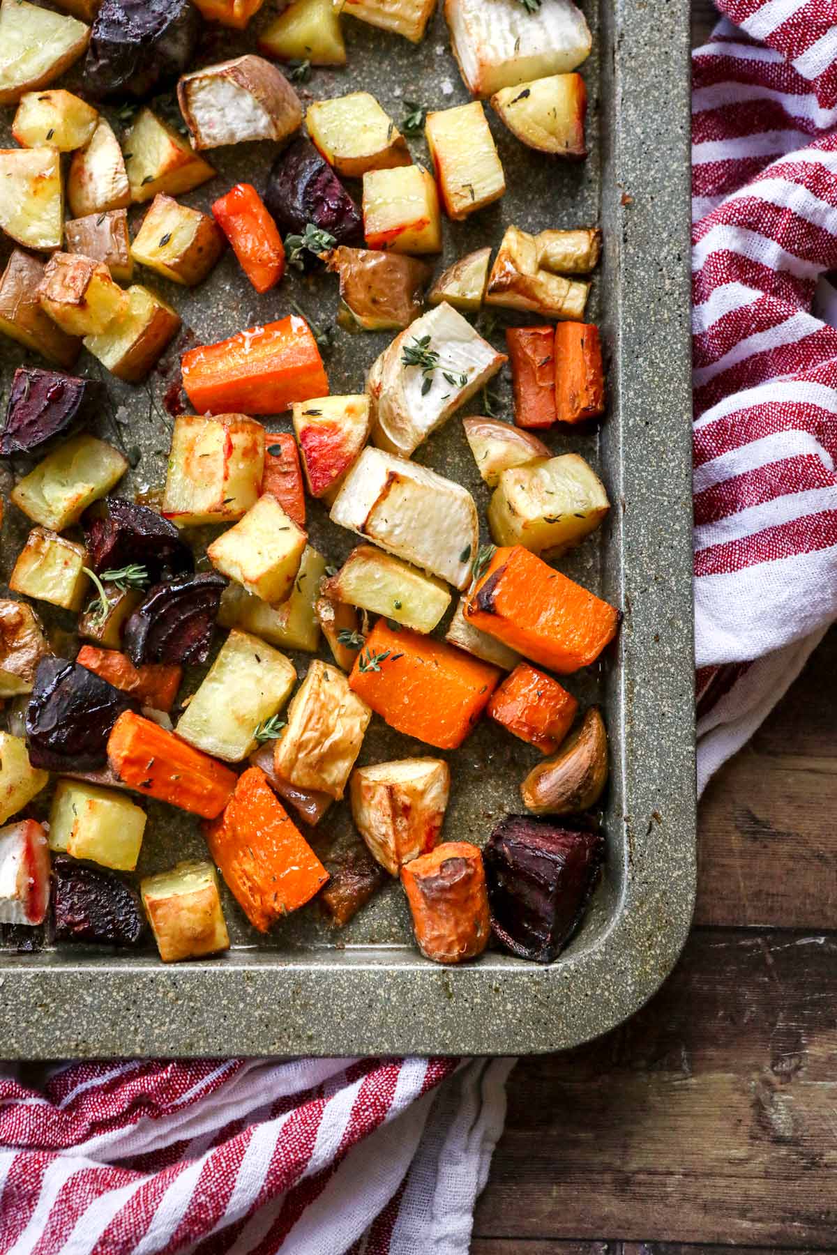 Roasted Winter Vegetables pieces cooked on sheet pan close up