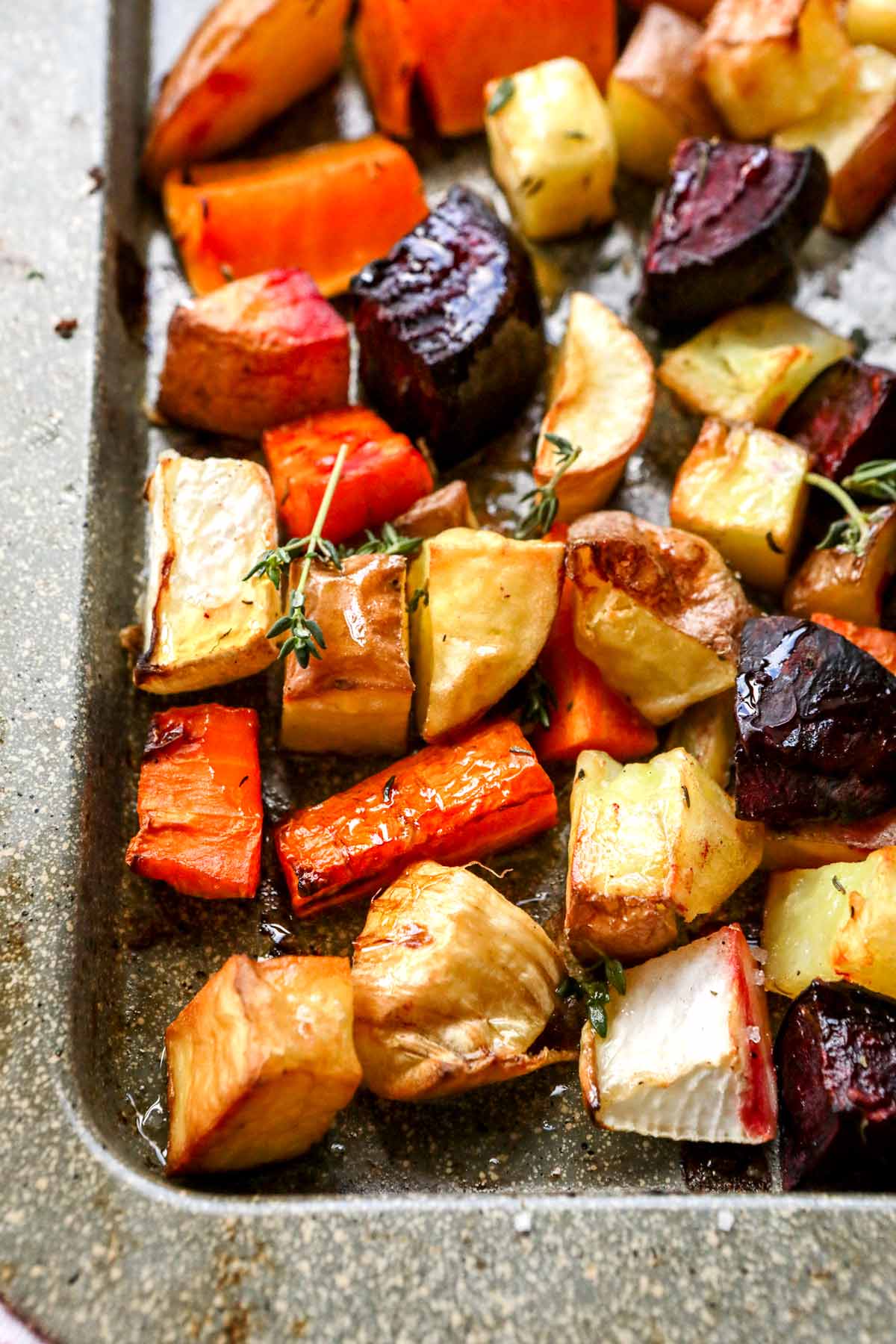 Roasted Winter Vegetables pieces cooked on sheet pan close up