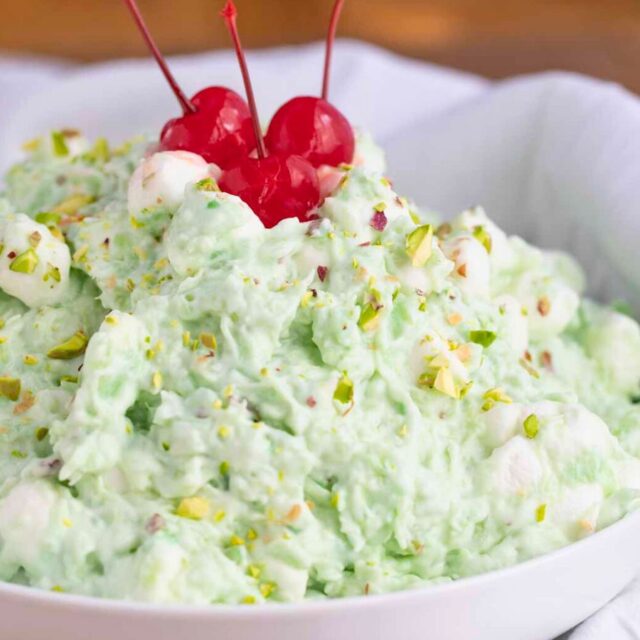 bowl of prepared salad with cherries on top