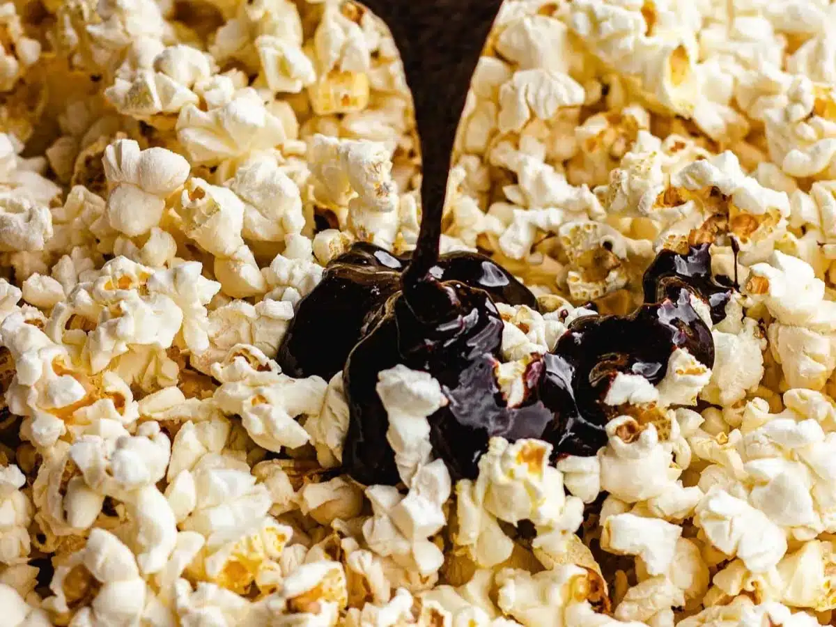 Sauce being poured on top of popcorn.