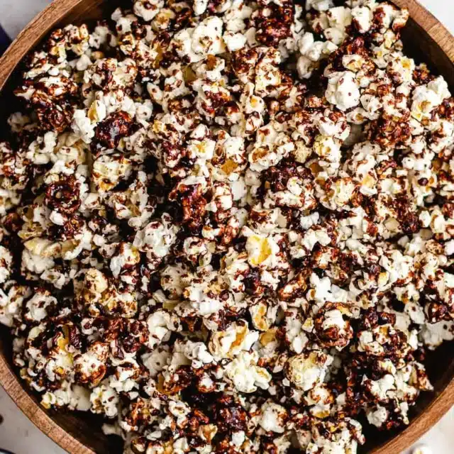 Bowl of popcorn with sweet saucy topping.