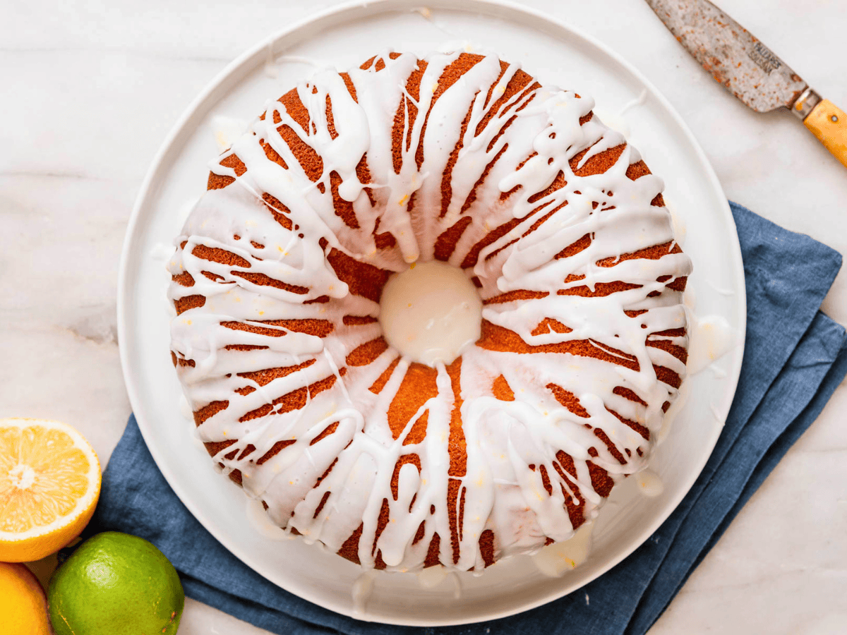 top view of circular cake with white icing on a white plate