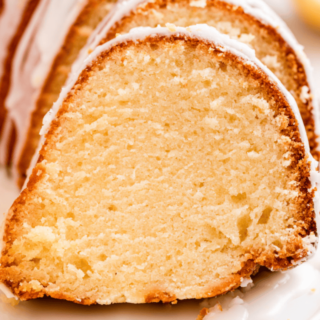 slices of cake with icing on a whtie plate