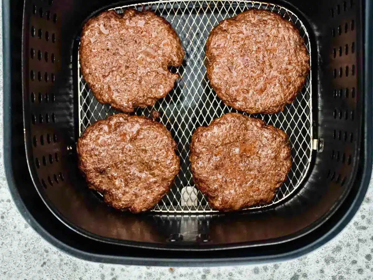 Cooked burger patties in air fryer