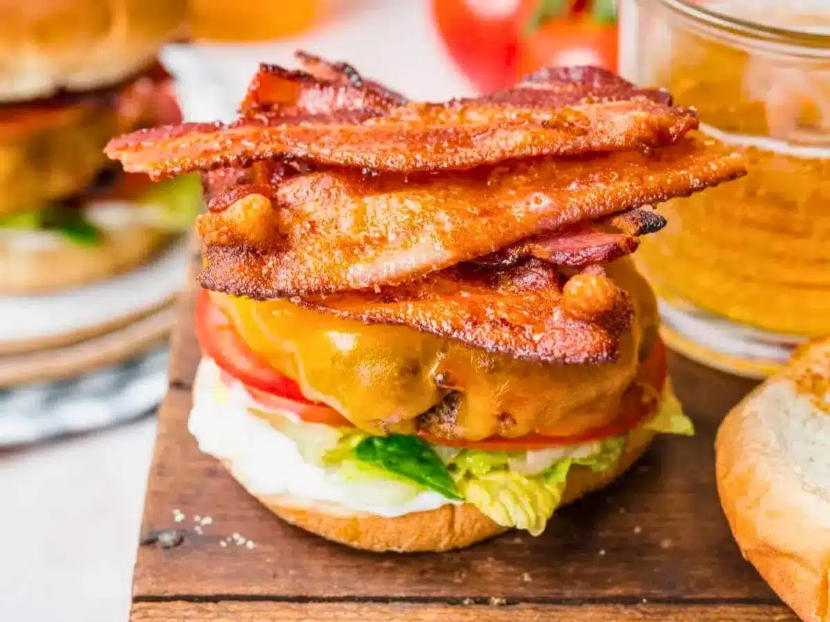 Cheeseburger topped with bacon and no top bun