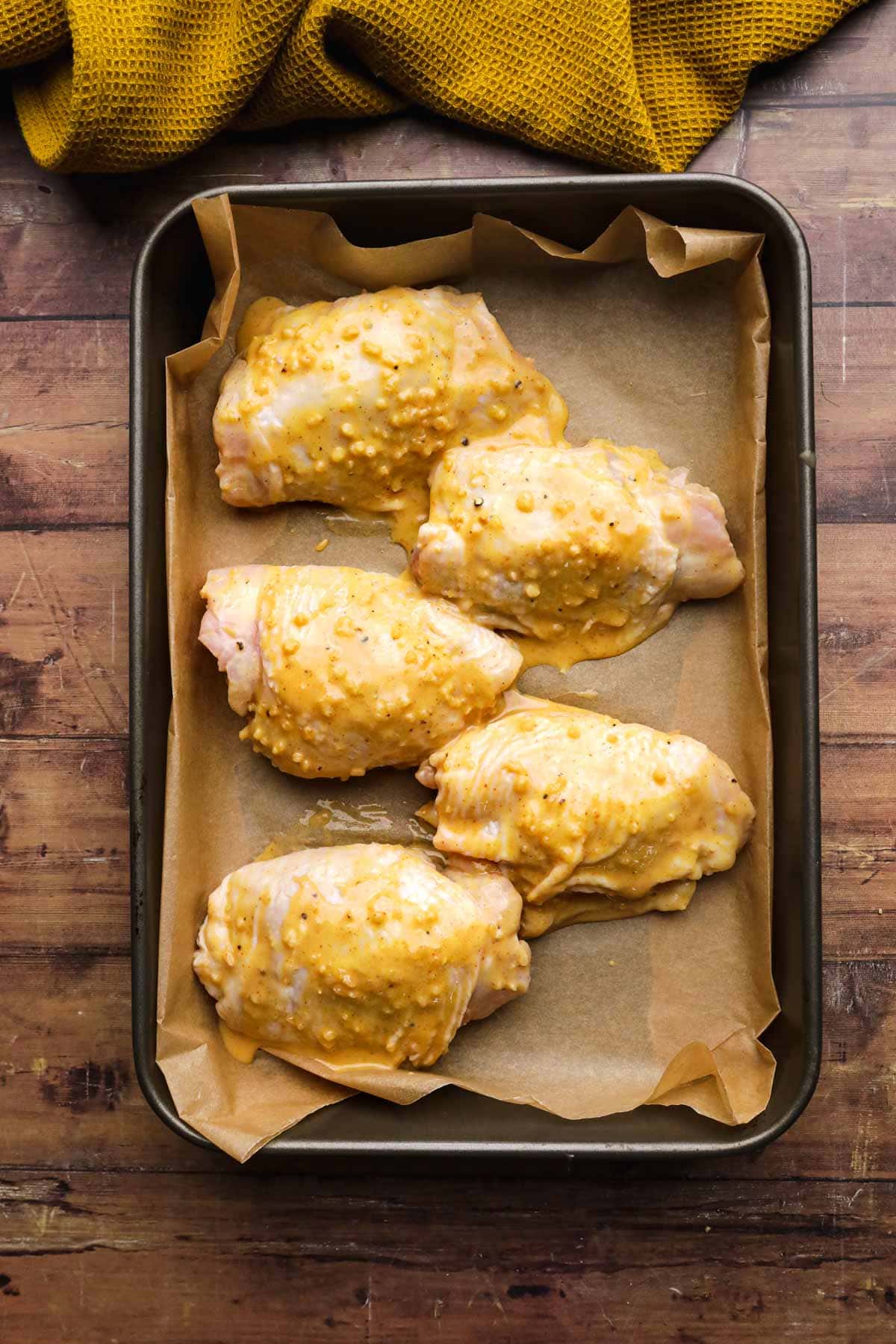 Baked Sweet and Spicy Honey Chicken raw chicken thighs on baking sheet